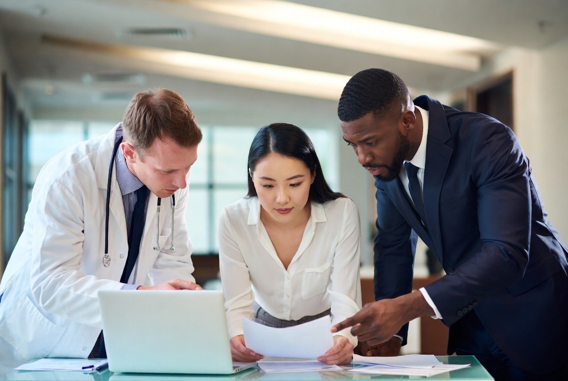 Healthcare and IT leadership reviewing a patch management report together